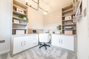 A home office with neural colour cabinets, shelving and chair